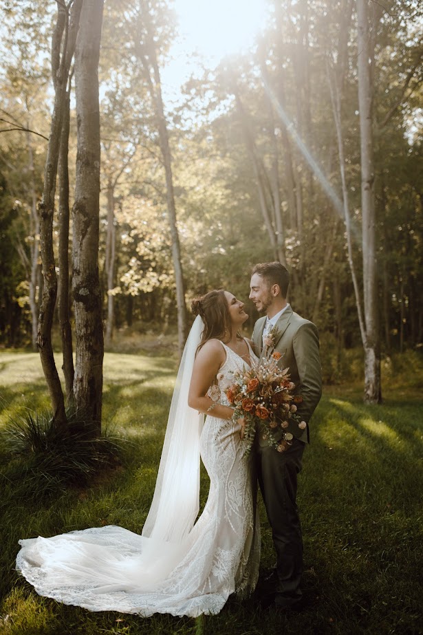 bride and groom in wooded area