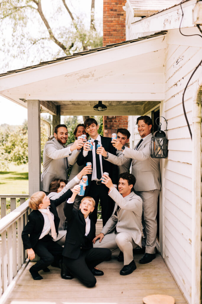 groomsmen on farmhouse porch