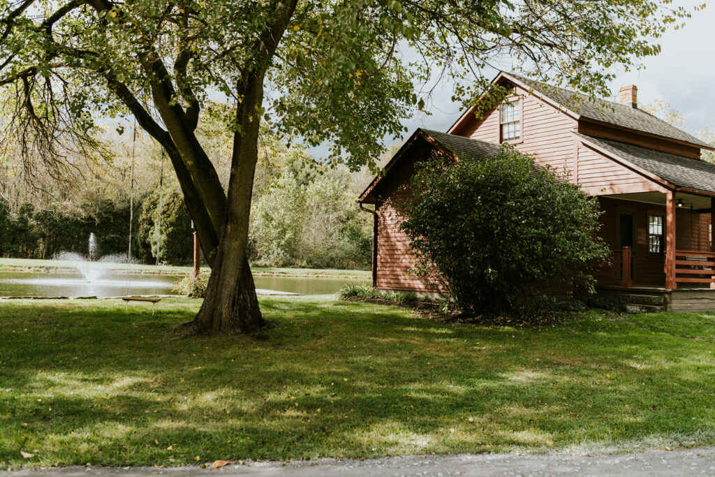 cottage beside pond with fountain