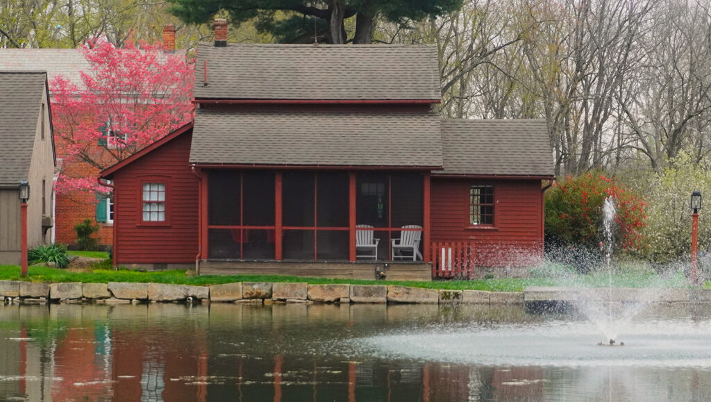rural cottage at pond with fountain