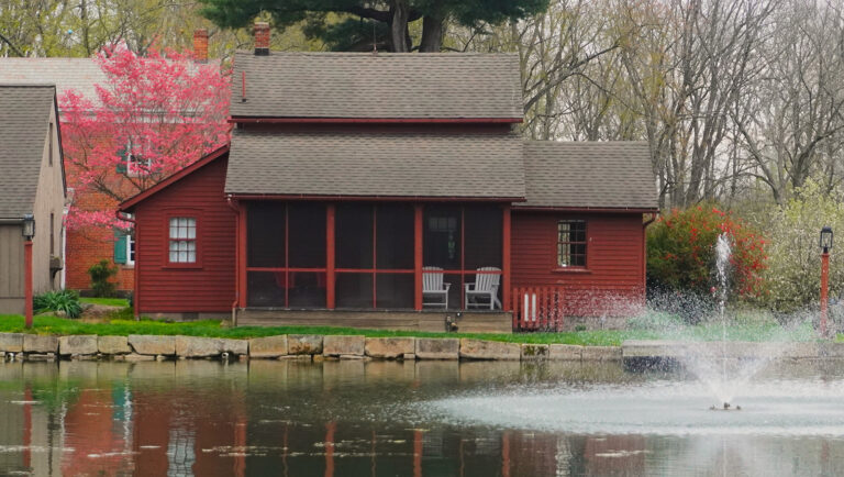 rural cottage at pond with fountain