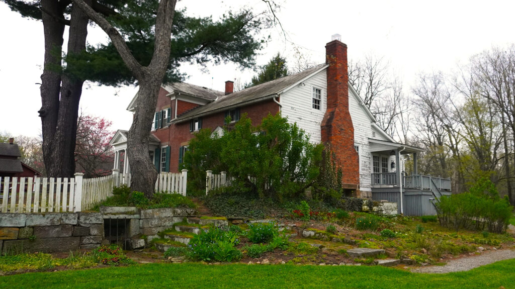 farmhouse with white picket fence