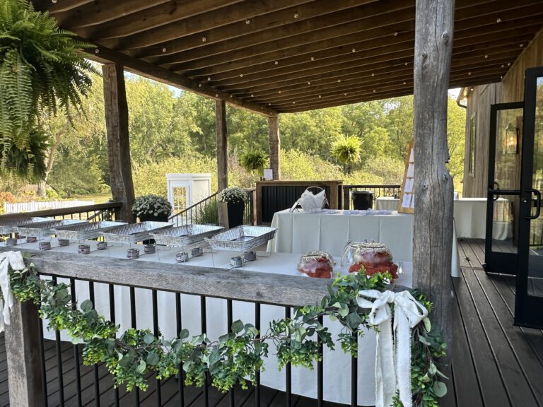 buffet set up on porch of rustic Ohio barn wedding venue