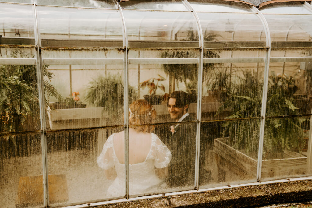 bride and groom in greenhouse