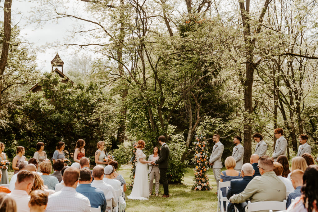 bride and groom outdoor wedding ceremony in wooded area