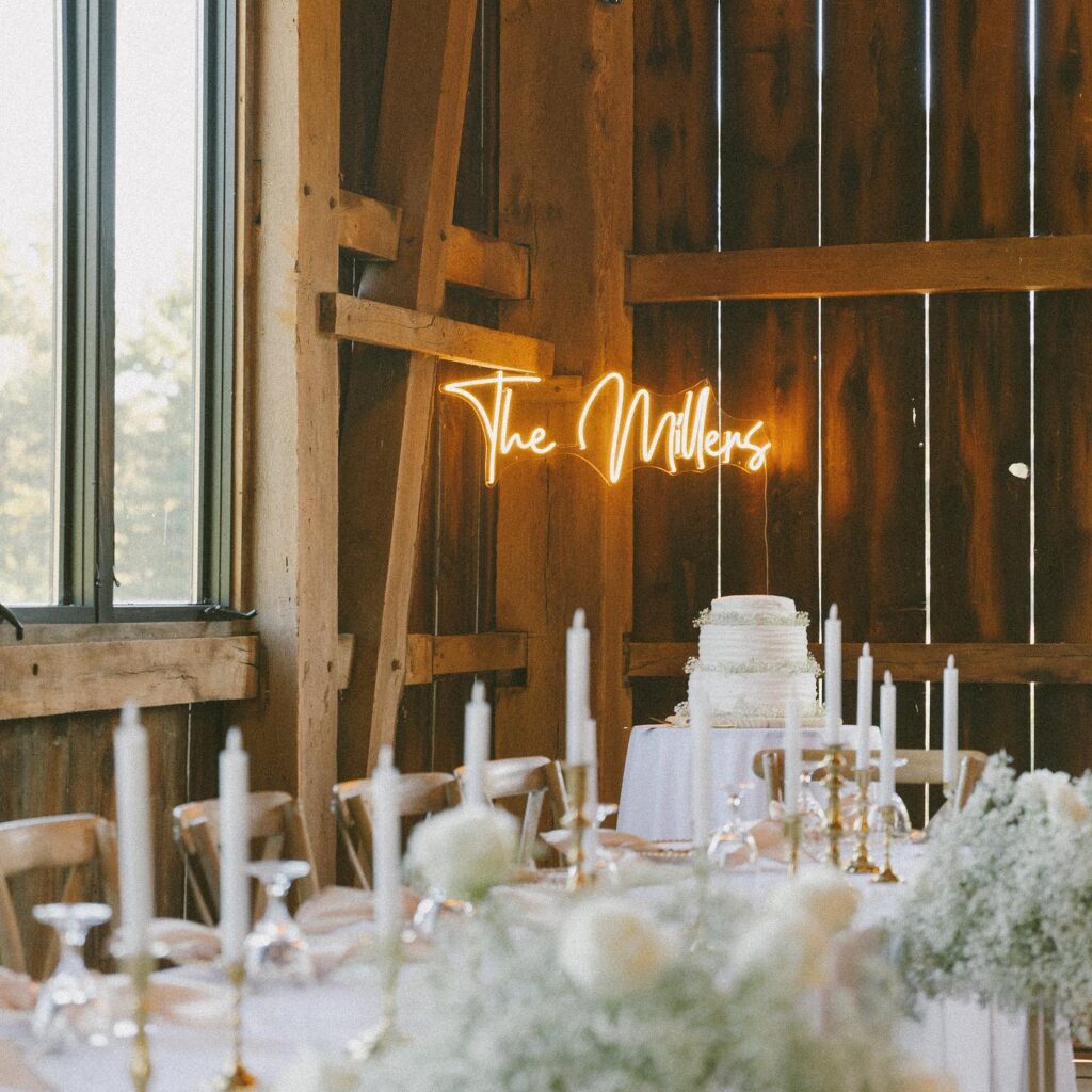 wedding cake, candles and decor in rustic barn